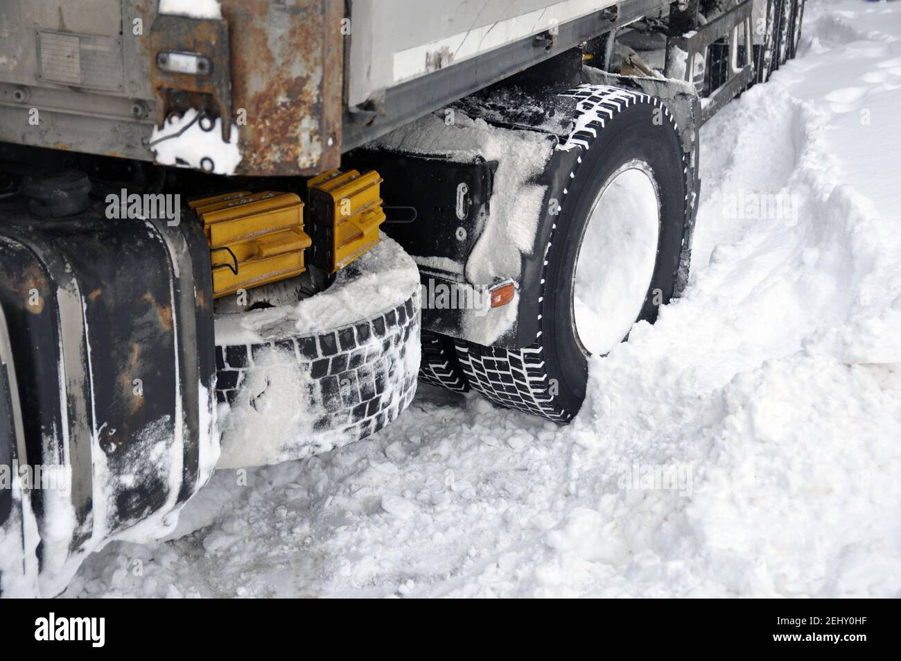 Heavy vehicle stuck in the snow on the road. Stock Photo