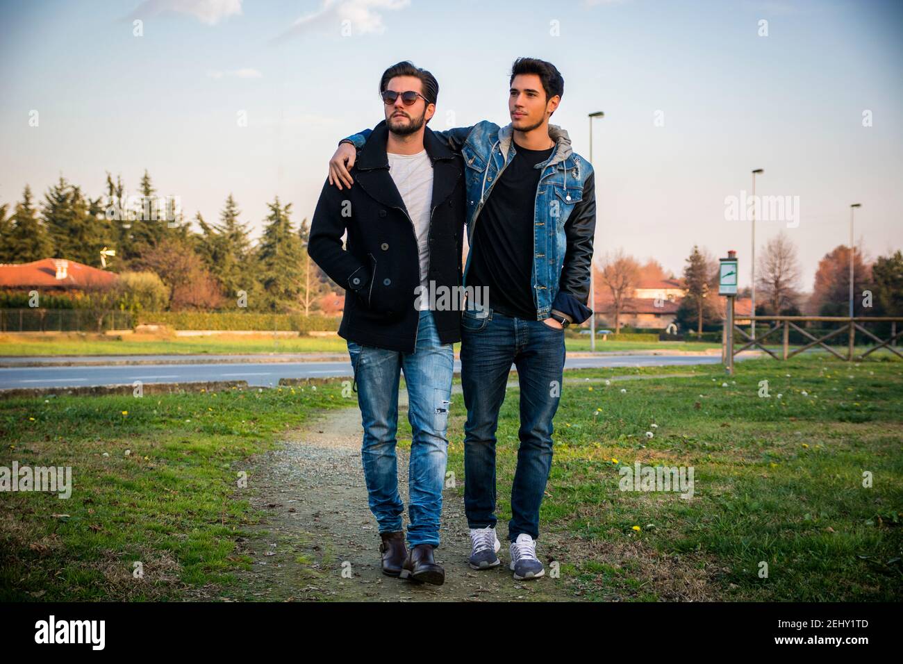 Two handsome young men, friends, in a park Stock Photo