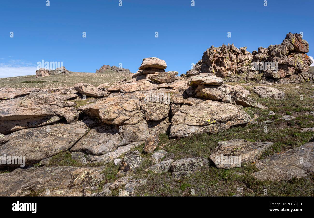 The Rocky Mountains orop with rocks and grasses under bright blue sky near Estes Park, Colorado, USA. Stock Photo