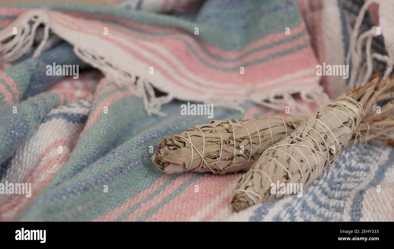 Dried white sage smudge stick, relaxation and aromatherapy. Smudging during psychic occult ceremony, herbal healing, yoga or aura cleaning. Essential Stock Photo