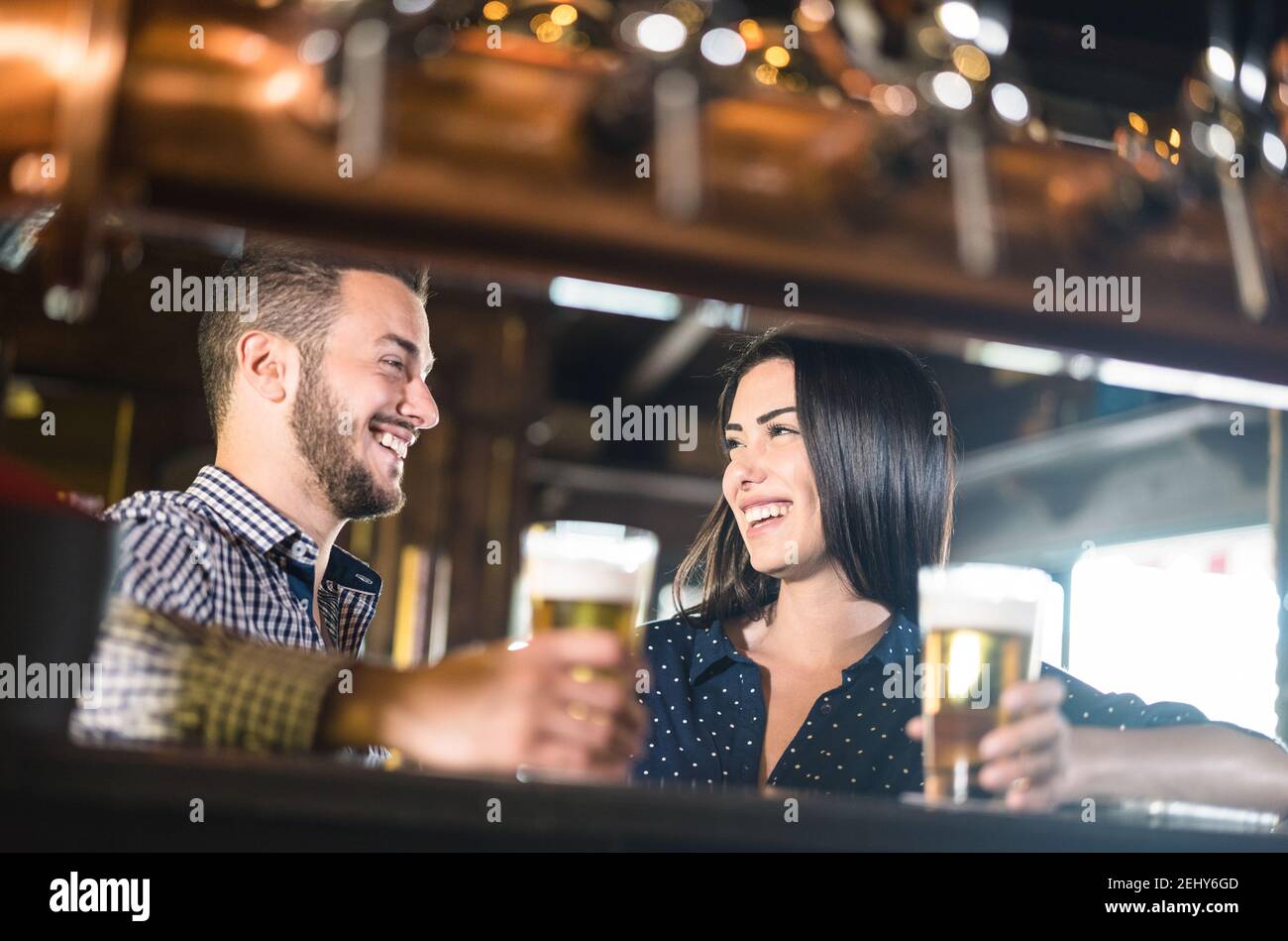 Young couple at beginnings of love story Pretty woman drinking beer