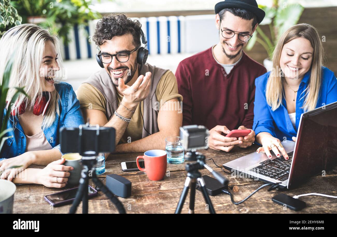 Young happy friends sharing content on streaming platform with digital web camera - Modern marketing concept with millenial guys and girls having fun Stock Photo
