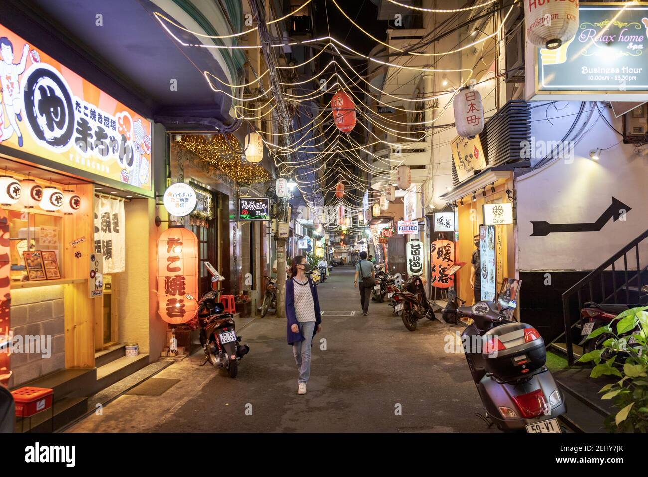 People walking down the street in Little Tokyo, Japanese quarter  in Ho Chi Minh City at night Stock Photo