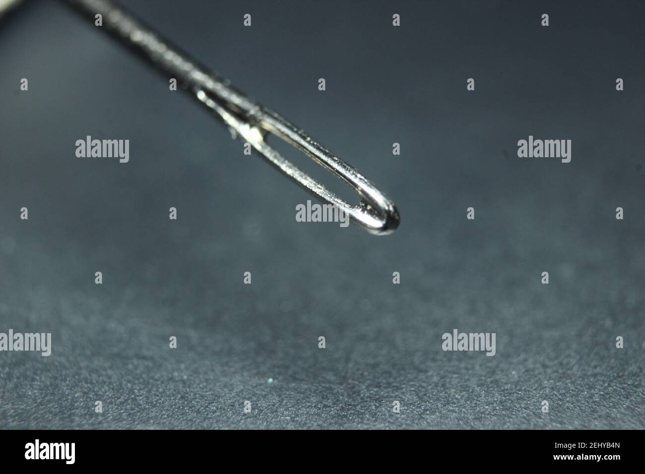 Macro shot of sewing needle with empty eyelet against a black background Stock Photo