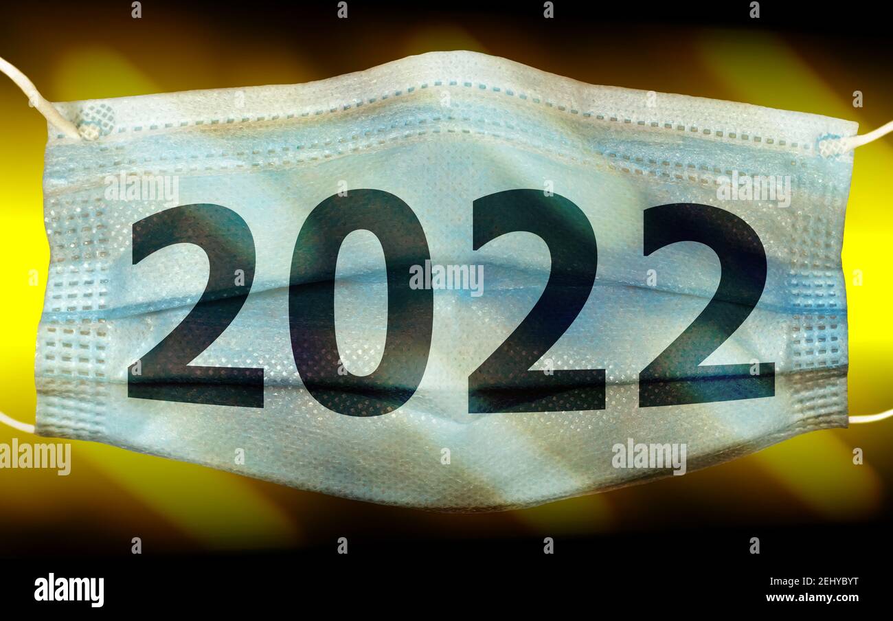 year 2022 concept with numbers against medical mask on dark abstract