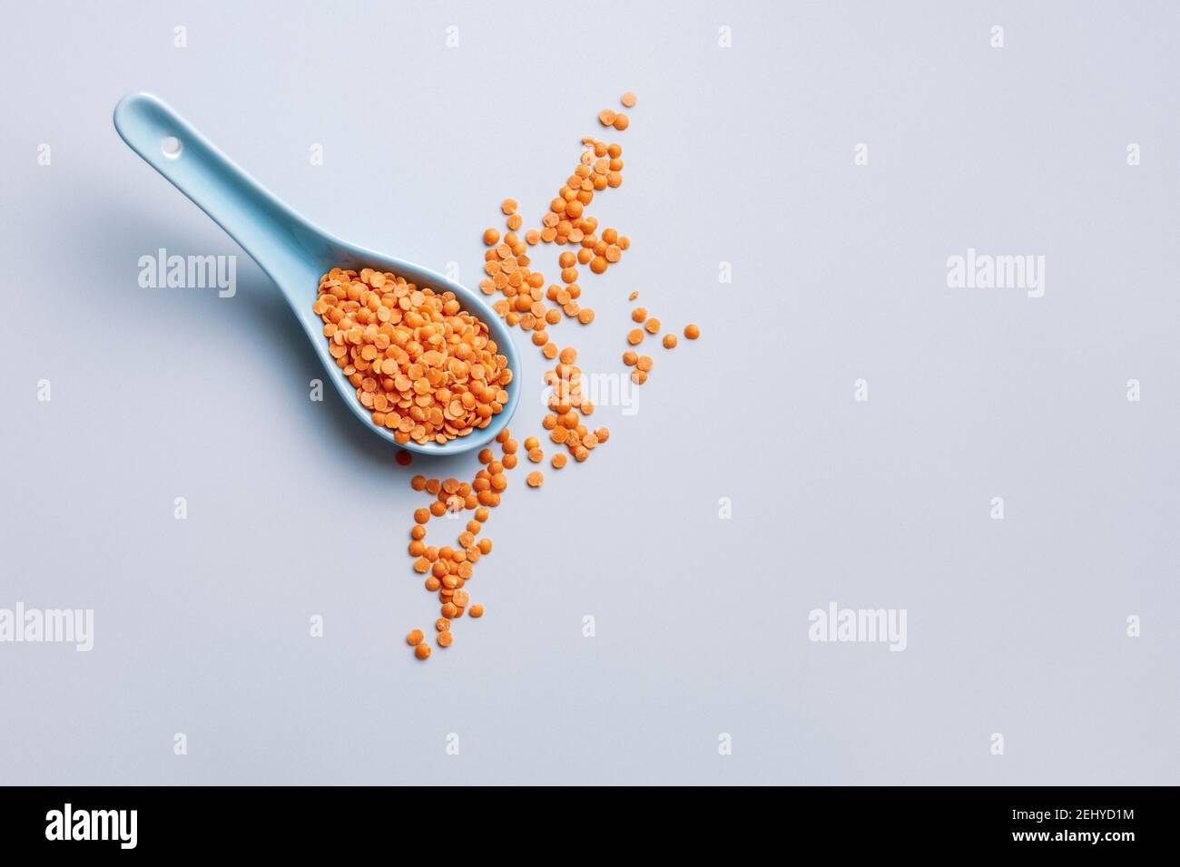 A spoonful of uncooked red split lentils Stock Photo