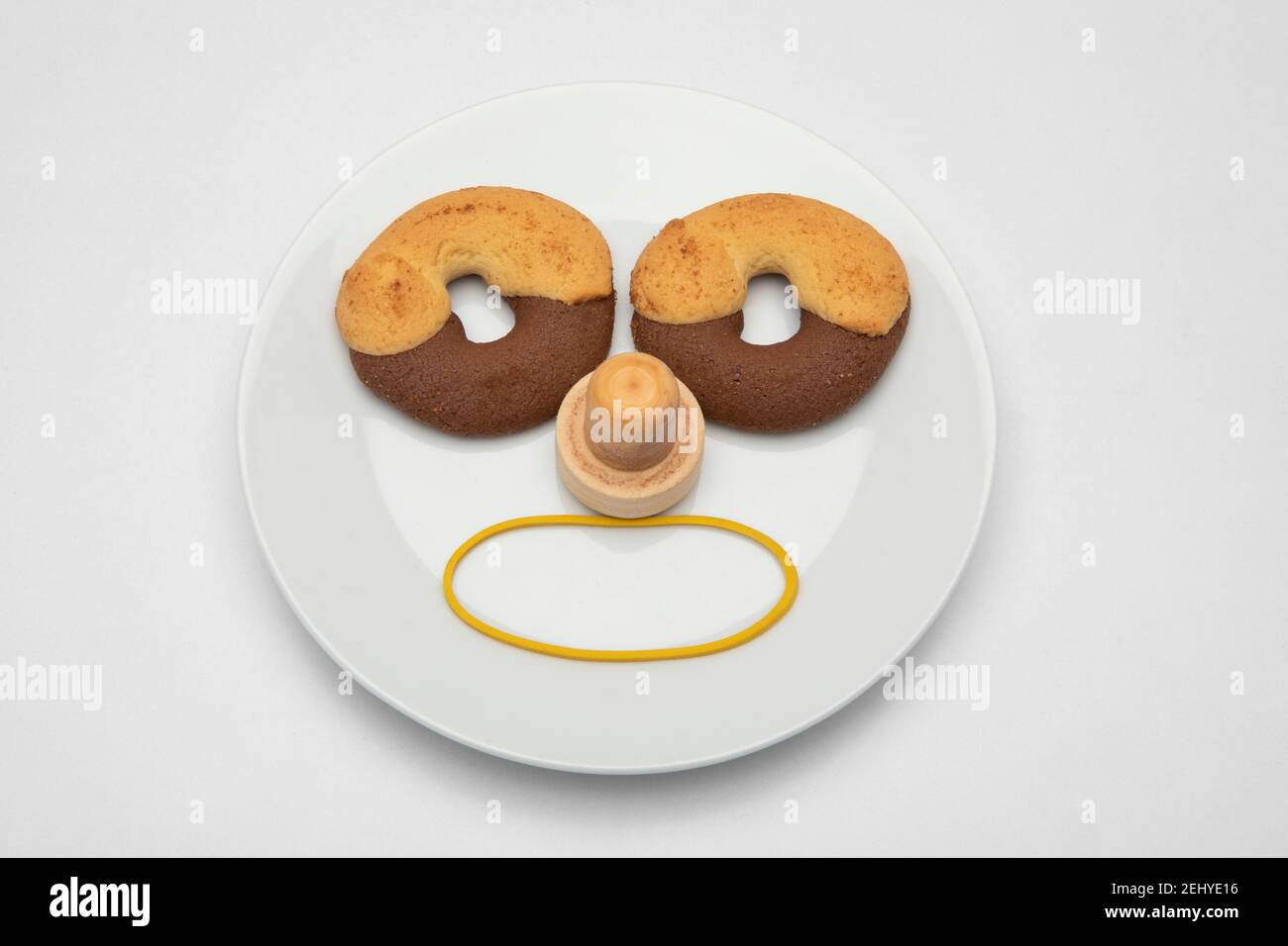 a face made of biscuits on a plate with open mouth Stock Photo
