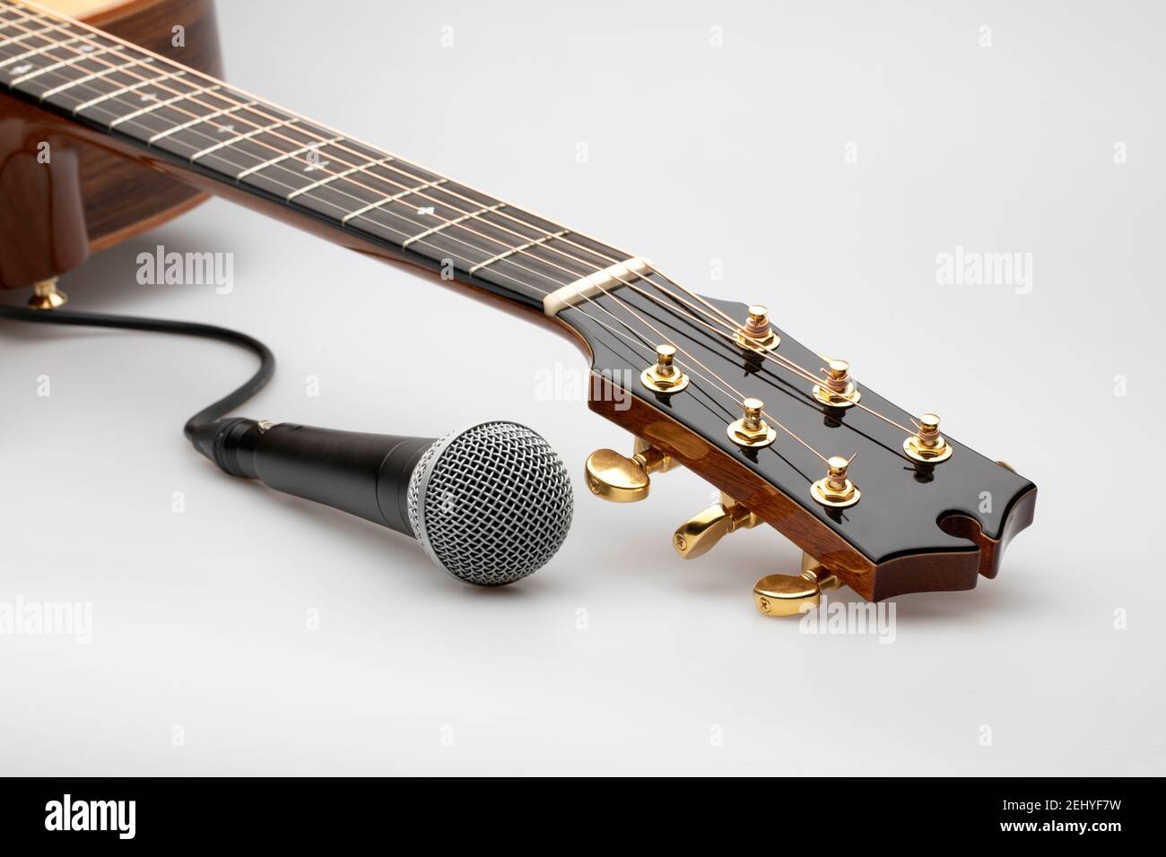 Acoustic guitar neck with microphone on white background Stock Photo