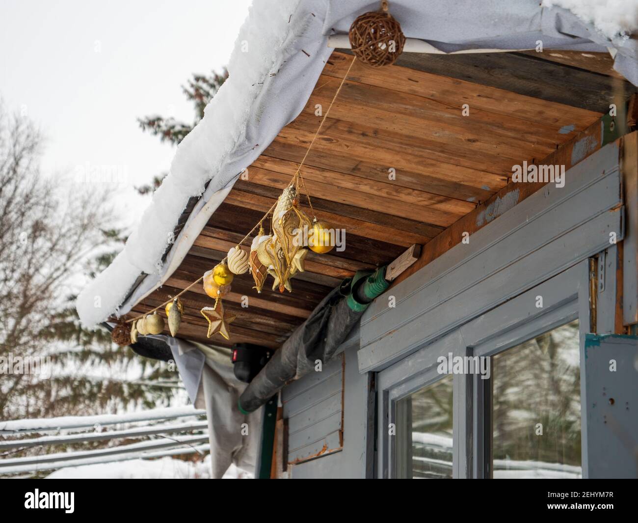 Christmas decorations glass globes on the chalet covered with snow early in the winter Stock Photo