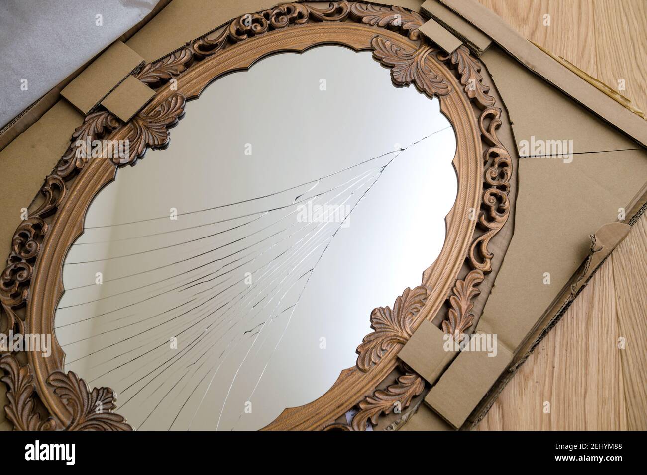 View from above of broken mirror vintage wooden frame with a damaged
