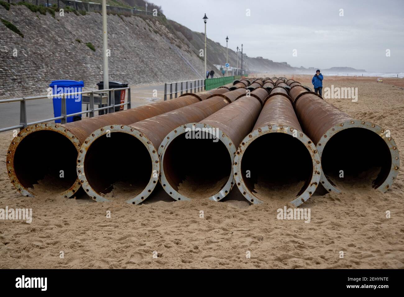 Large bore steel pipes used for pumping dredged sand to build up the beach protecting the coast from erosion on the beach at Fisherman’s Walk, Southbo Stock Photo