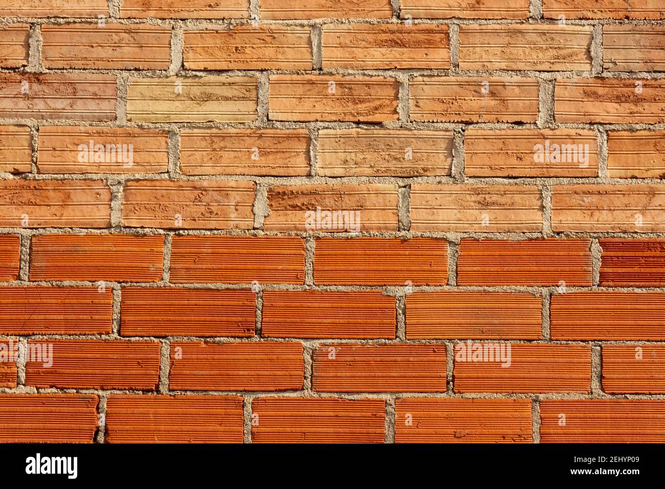 Red brick wall with textured surface creating a rustic and sturdy appearance for construction design Stock Photo