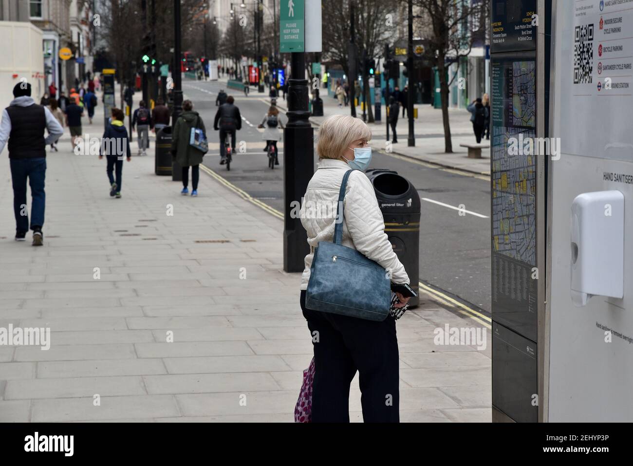 Oxford Street, London, UK. 20th Feb 2021. People in London on a warm Saturday in lockdown with all none essential shops still closed. Credit: Matthew Chattle/Alamy Live News Stock Photo