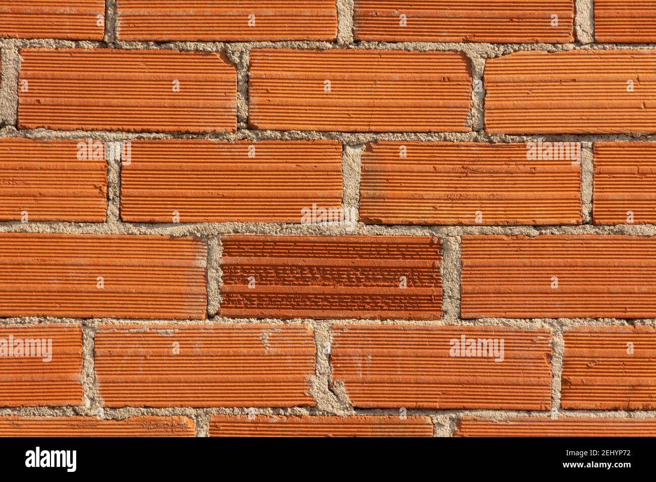 Red brick wall with textured surface creating a rustic and sturdy appearance for construction design Stock Photo