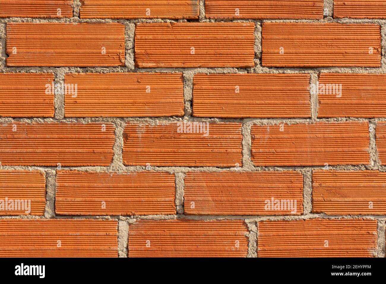 Red brick wall with textured surface creating a rustic and sturdy appearance for construction design Stock Photo
