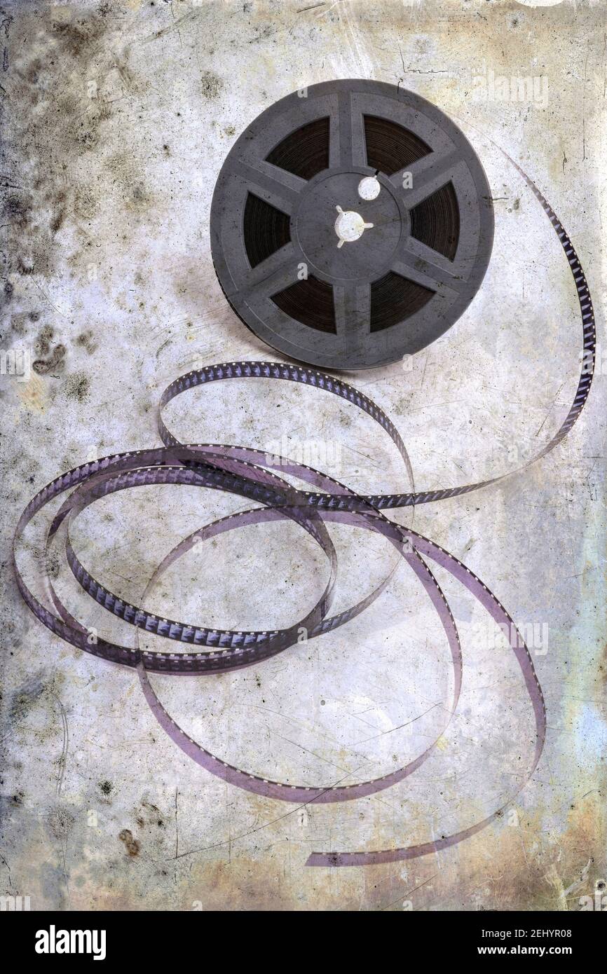 Film reel with unspooled film strips placed on a neutral background in ...