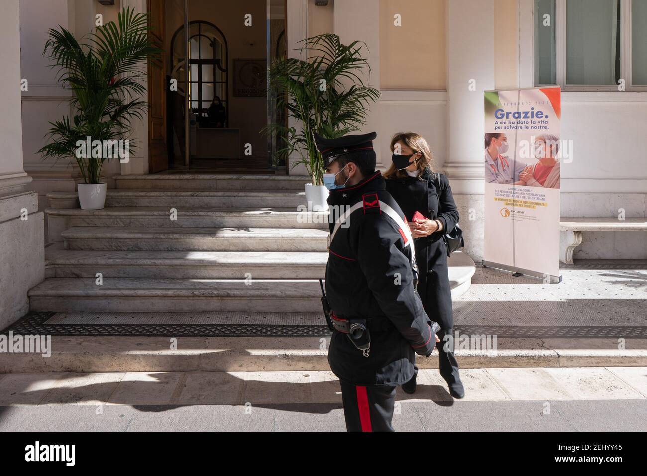 Carabinieri member and a guest are seen at the entrance.The National Federation of the Orders of Doctors and Dental Surgeons (FNOMCeO) celebrated the National Day of Healthcare Workers, Healthcare Members, Assistance Workers and Volunteers in Rome. The celebration is dedicated to the memory of doctors and dentists who died due to Covid-19 and it was going live at the Civic Hospital in Codogno and Berlin. Several authorities and celebrities like Maria Elisabetta Alberti Casellati, Italian Senate President; Roberto Fico, President of the Italian Chamber of Deputies and Roberto Speranza, Minister Stock Photo