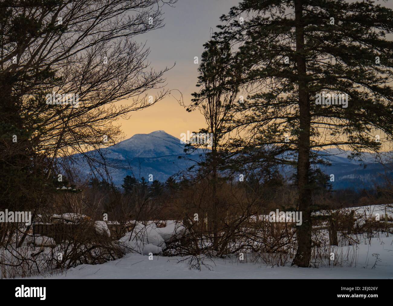 winter morning sun lighting up Camel's Hump mountain in Vermont Stock Photo