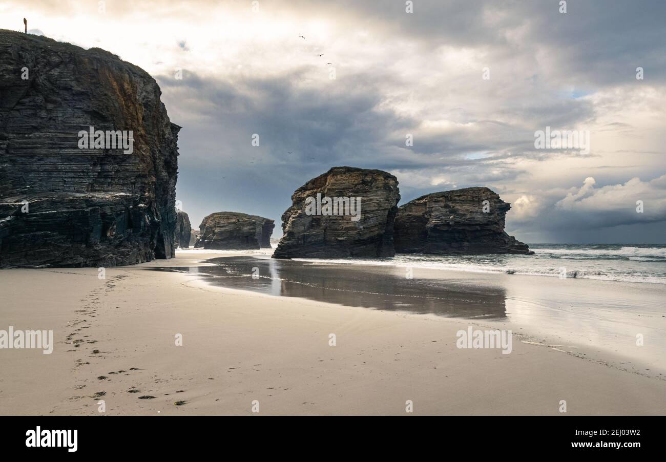 Scenic Playa de las Catedrales (Beach of the Cathedrals) featuring stunning rock arches, during low tide. Stock Photo