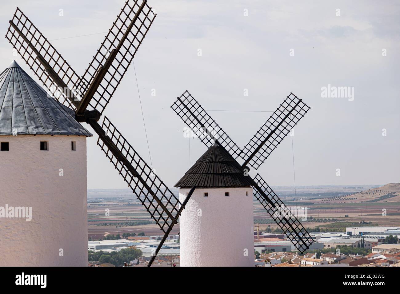 Old white windmills against a blue sky in Campo de Criptana, Castile la Mancha, Spain. Stock Photo