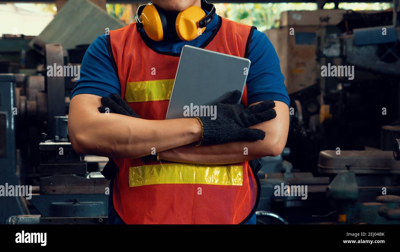 Young skillful factory worker or engineer close up portrait in factory