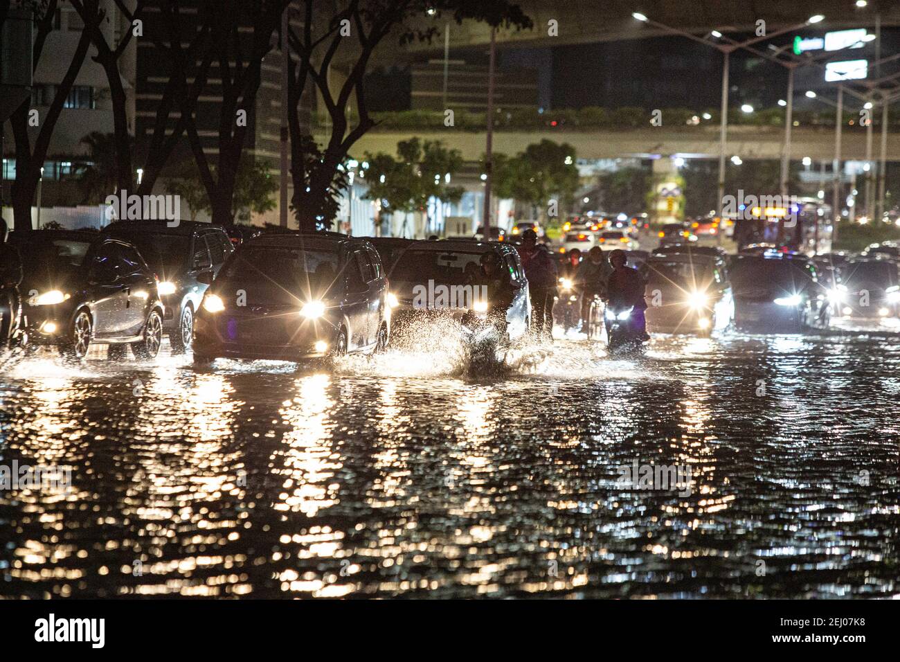 Jakarta, Jakarta, Indonesia. 20th Feb, 2021. A view of traffic jam during a flood following heavy rains at business district in Jakarta, Indonesia on February 20, 2021. At least 21 areas in the Indonesian capital were hit by floods Saturday following heavy rains, during which thousands of homes were also damaged, according to the National Board for Disaster Management Credit: Afriadi Hikmal/ZUMA Wire/Alamy Live News Stock Photo