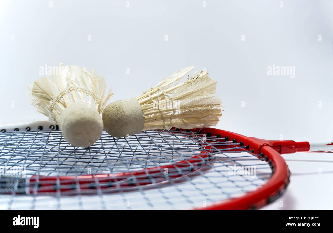 two red badmintong rackets together with Shuttlecocks on top. weird sports. unusual sports. youth sports. Stock Photo