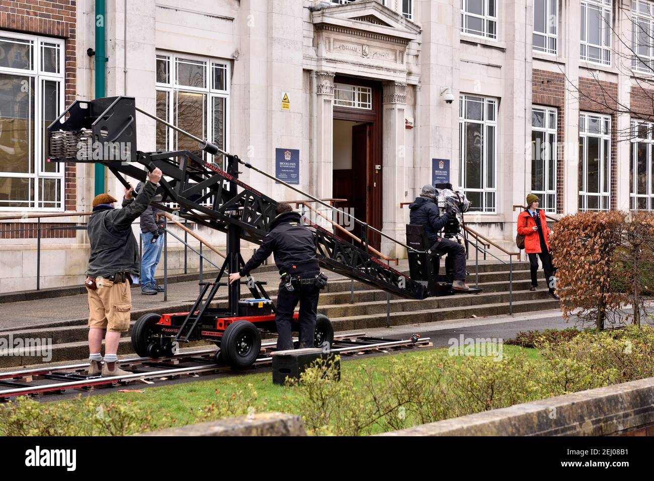Location filming of Alex Rider story, cameraman on crane platform, crew taking outdoor shoot at Brookland Secondary School for Amazon Prime Stock Photo