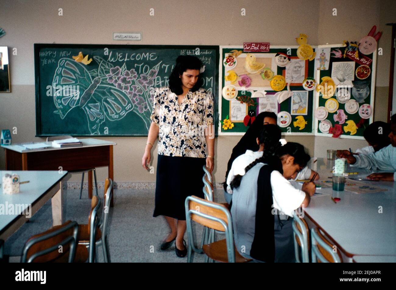 Abu Dhabi UAE School Teacher and Pupils in Classroom Stock Photo