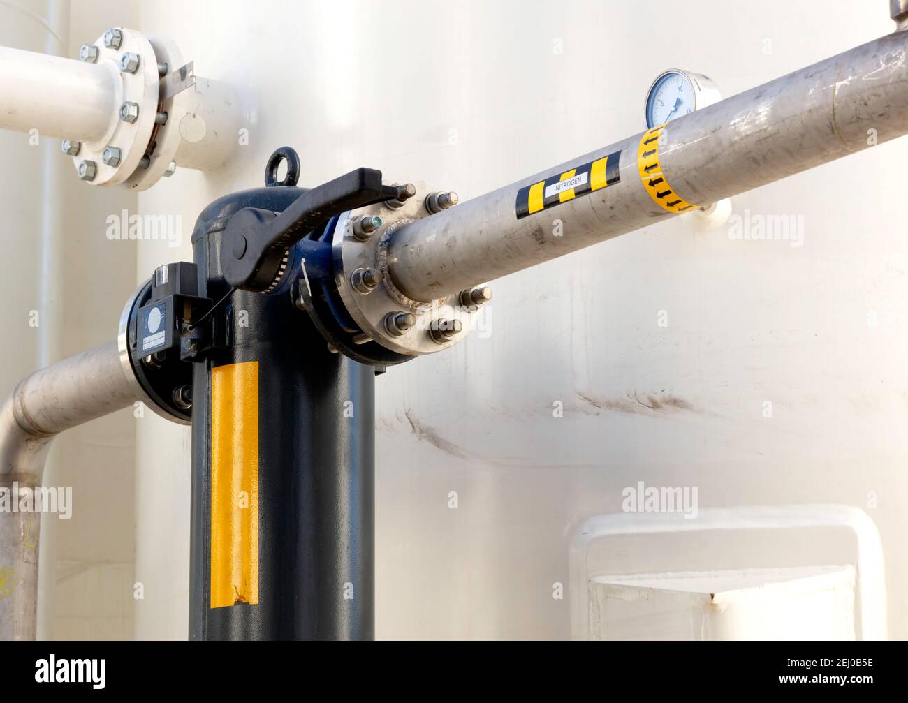 industry installation with a gas valve open and filter color blach, iron pipes and bolts for high pressure system Stock Photo