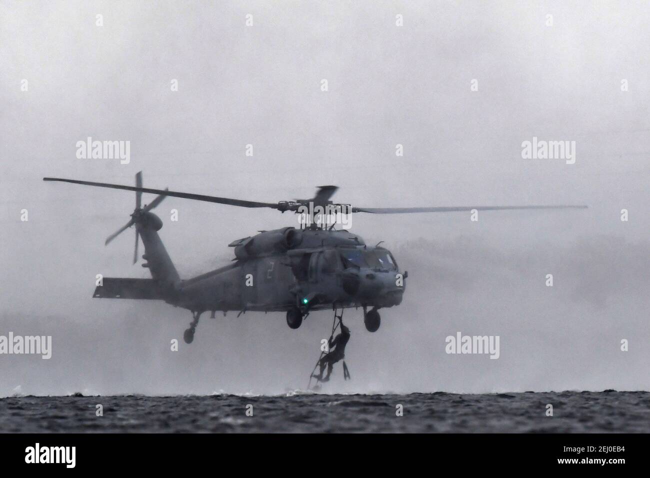 U.S. Air Force Special Tactics teams assigned to the 24th Special Operations Wing, conduct hoist operations with a Navy MH-60 Seahawk helicopter during Emerald Warrior at Hurlburt Field February 18, 2021 in Mary Esther, Florida. Stock Photo