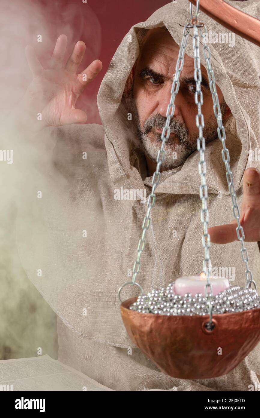 The old sorcerer casts magic spells Stock Photo