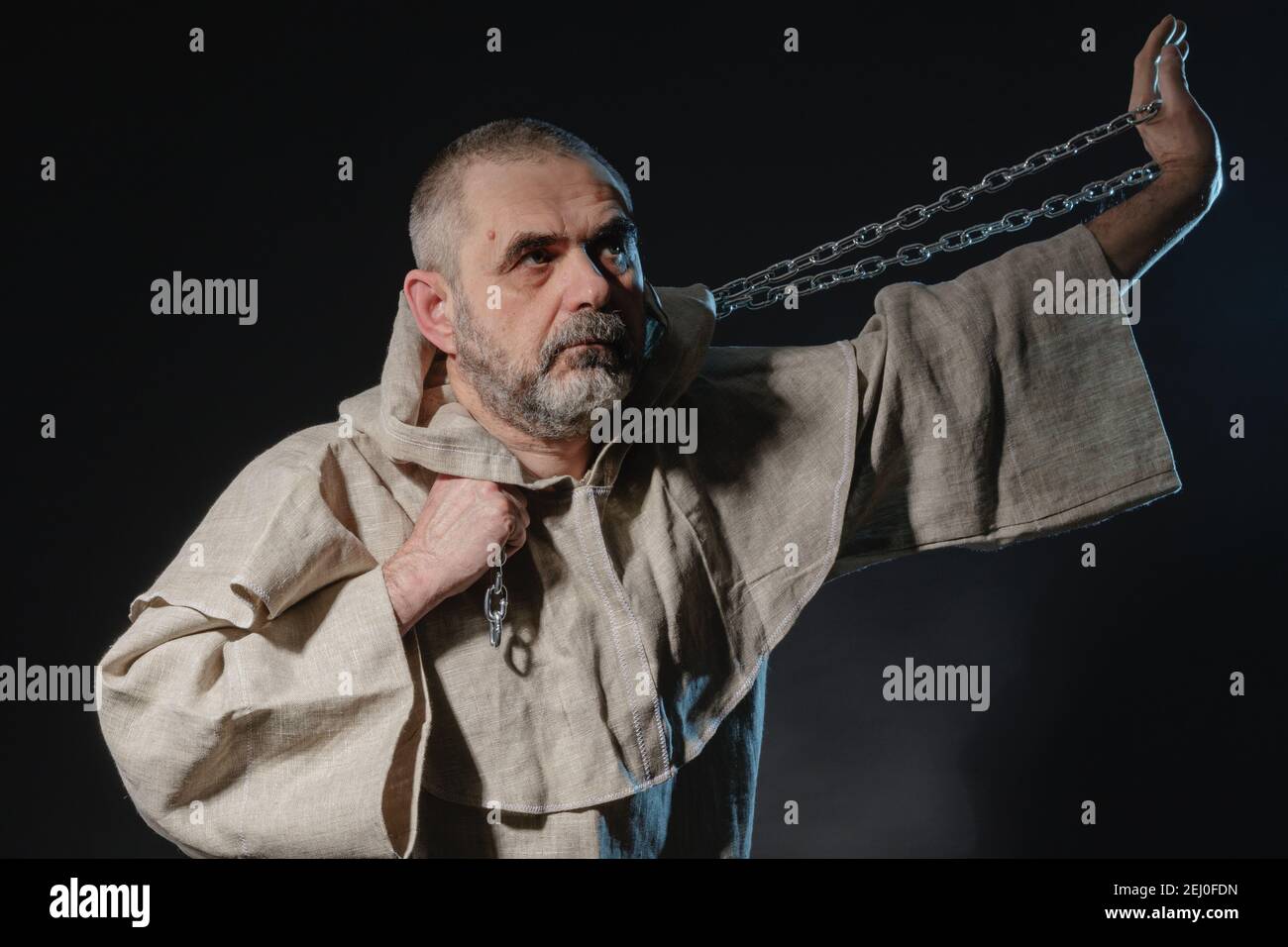 A wandering militant monk practicing a martial art with a chain in his hands Stock Photo