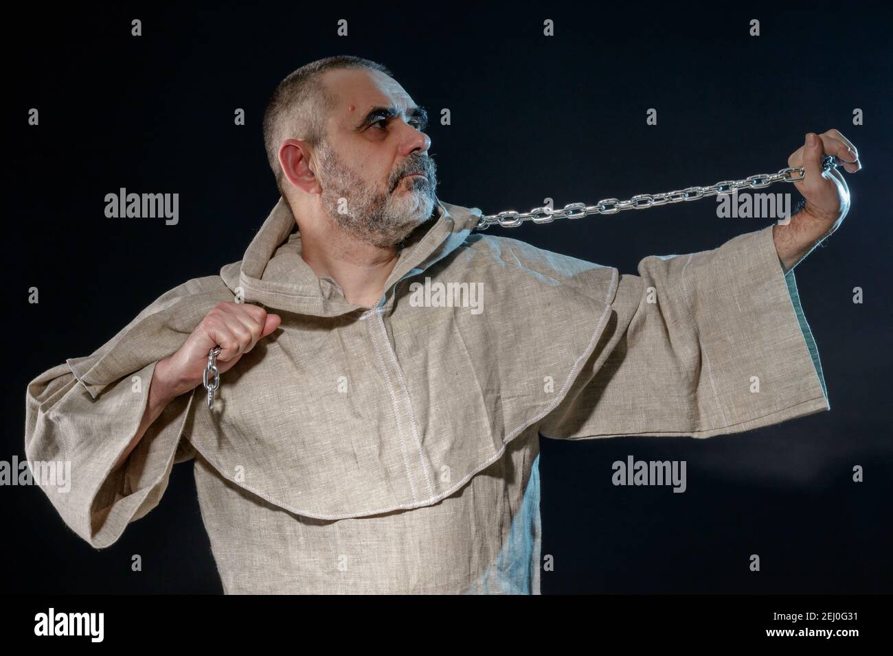 A wandering militant monk practicing a martial art with a chain in his hands Stock Photo