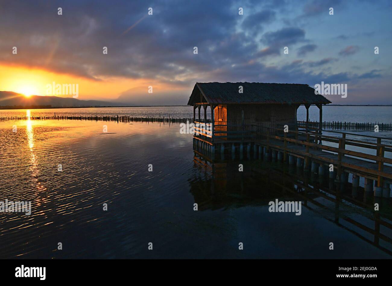 Sunrise landscape with a traditional wooden fisherman shack on the waters of Missolonghi Lagoon in Aetolia-Acarnania, Greece. Stock Photo
