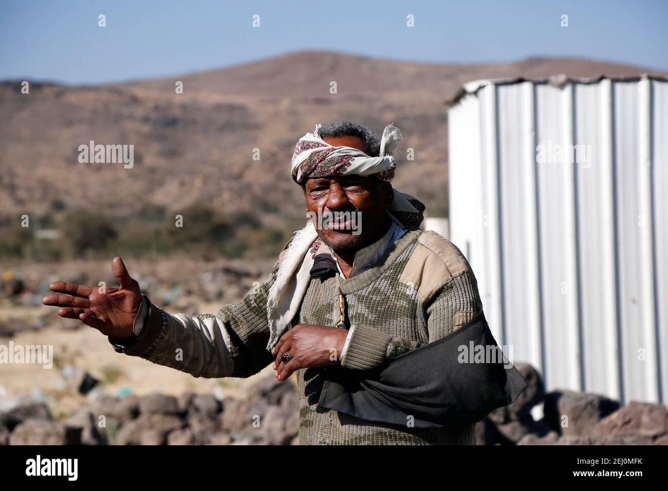 Sanaa, Yemen. 16th Feb, 2021. Ahamed Abyadh, who is an internally displaced person (IDP), stands outside his shelter at the Dharawan camp near Sanaa, Yemen, on Feb. 16, 2021. Credit: Mohammed Mohammed/Xinhua/Alamy Live News Stock Photo