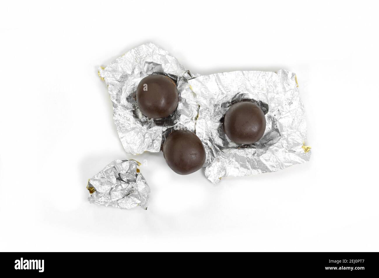 Mozartkugel closed up wrapped into foil , chocolate pralines isolated on white. Stock Photo
