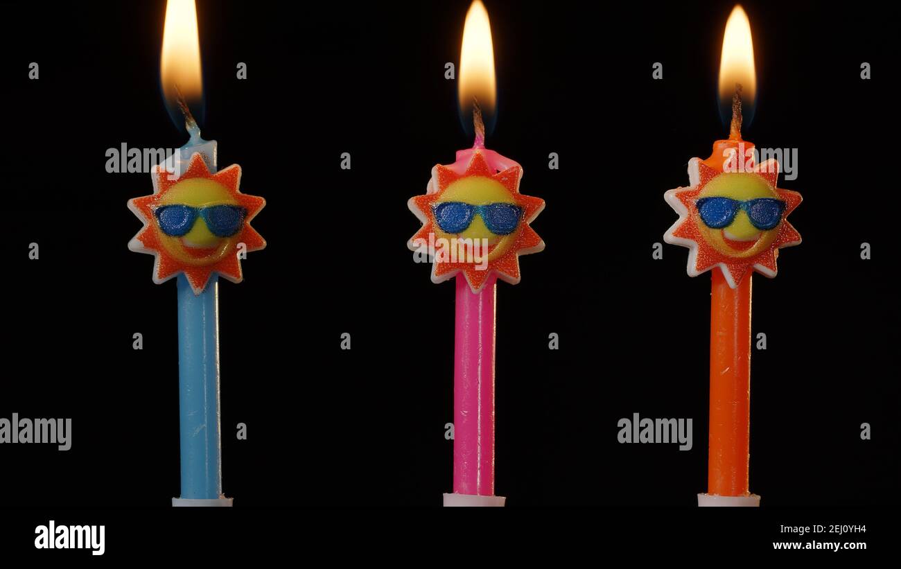 Funny Candles Birthday
 Birthday funny candles in form of sun in sunglasses isolated on black