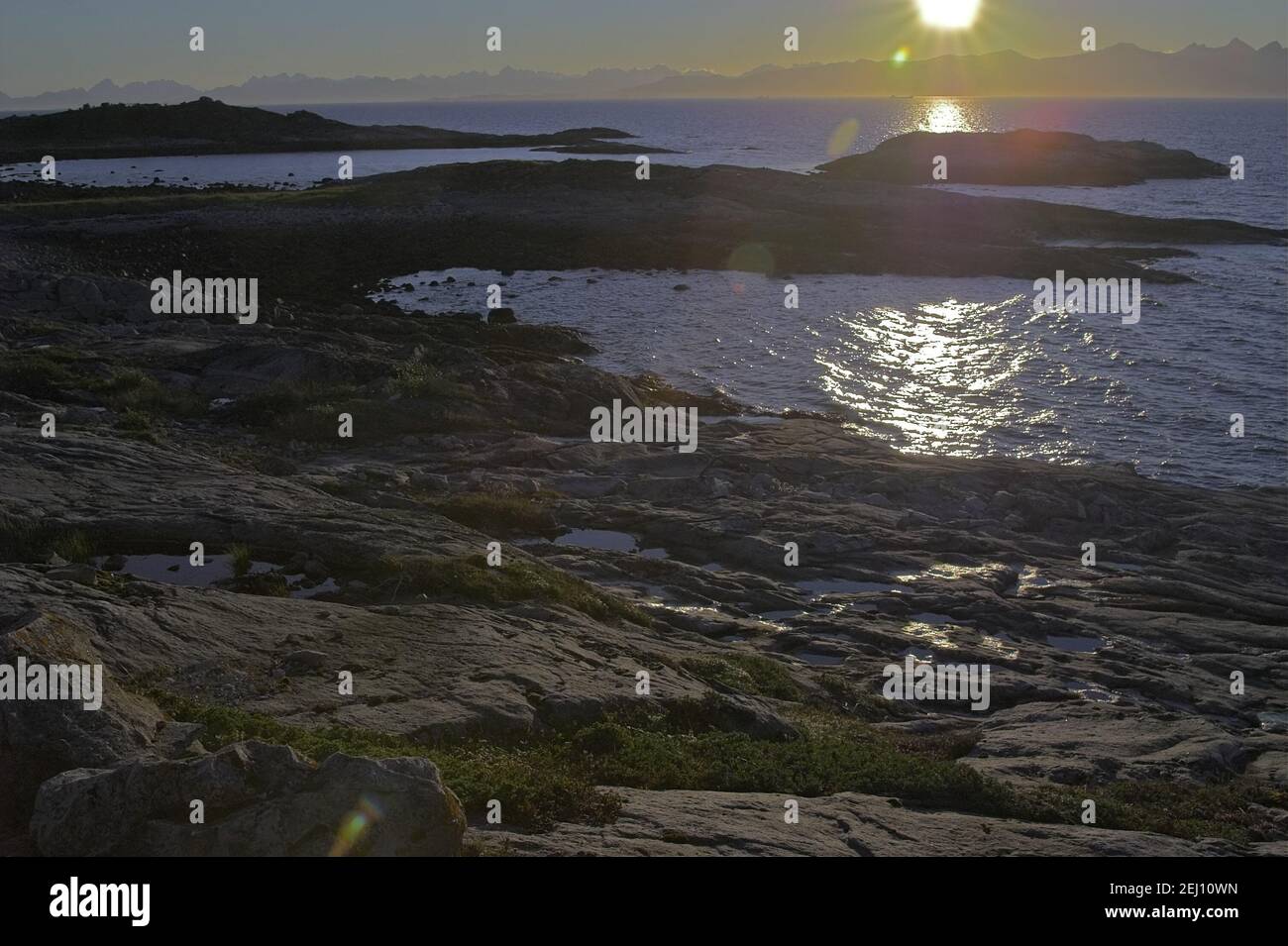 Norway, Norwegen; Sea rocks in the glow of the setting sun - the harsh landscape of Northern Norway. Seefelsen im Schein der untergehenden Sonne Stock Photo