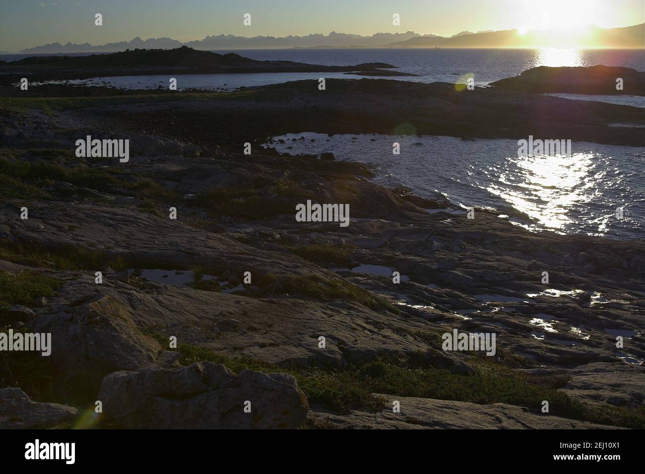 Norway, Norwegen; Sea rocks in the glow of the setting sun - the harsh landscape of Northern Norway. Seefelsen im Schein der untergehenden Sonne Stock Photo