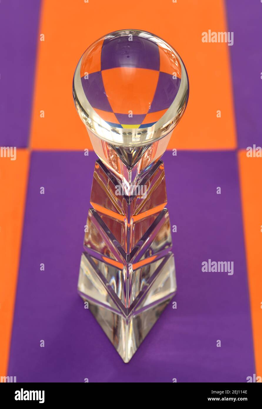 Glass ball on top of a crystal pedestal with refraction of purple and