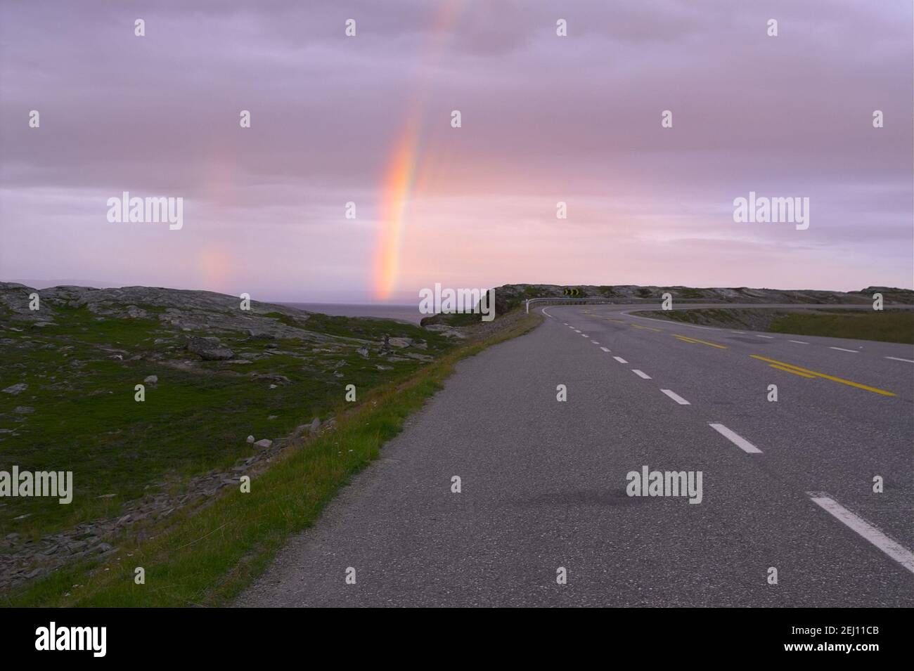 Norway, Norwegen; Rainbow and purple clouds lit in the evening in Northern Norway behind the Arctic Circle; Tęcza za kołem polarnym, wieczór, zmierzch Stock Photo