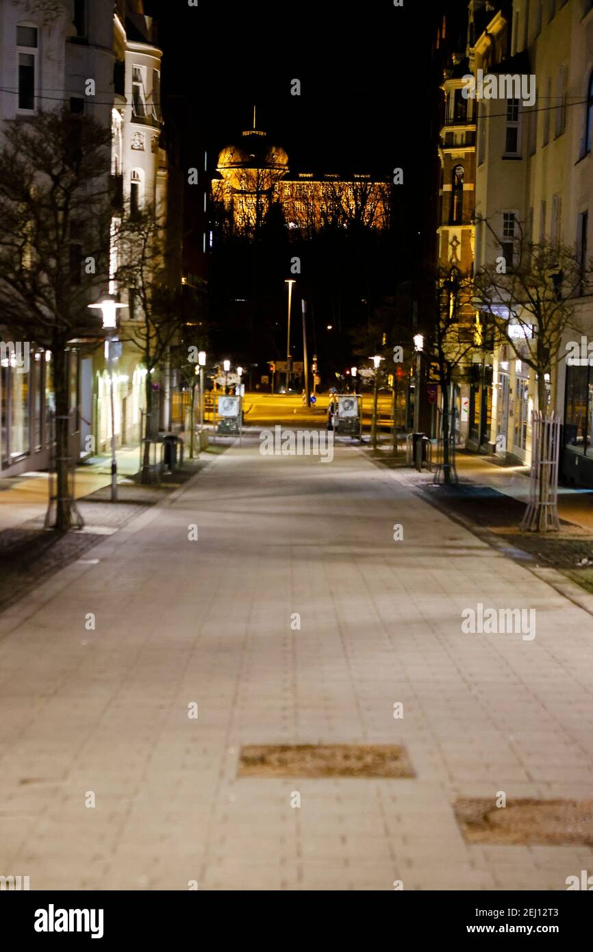 Flensburg, Germany. 20th Feb, 2021. Empty is the street in the city centre. On Saturday evening, February 20, a nightly curfew from 9 p.m. to 5 a.m. came into force in Flensburg. Previously possible meetings between a household and another person are not allowed. Credit: Frank Molter/dpa/Alamy Live News Stock Photo
