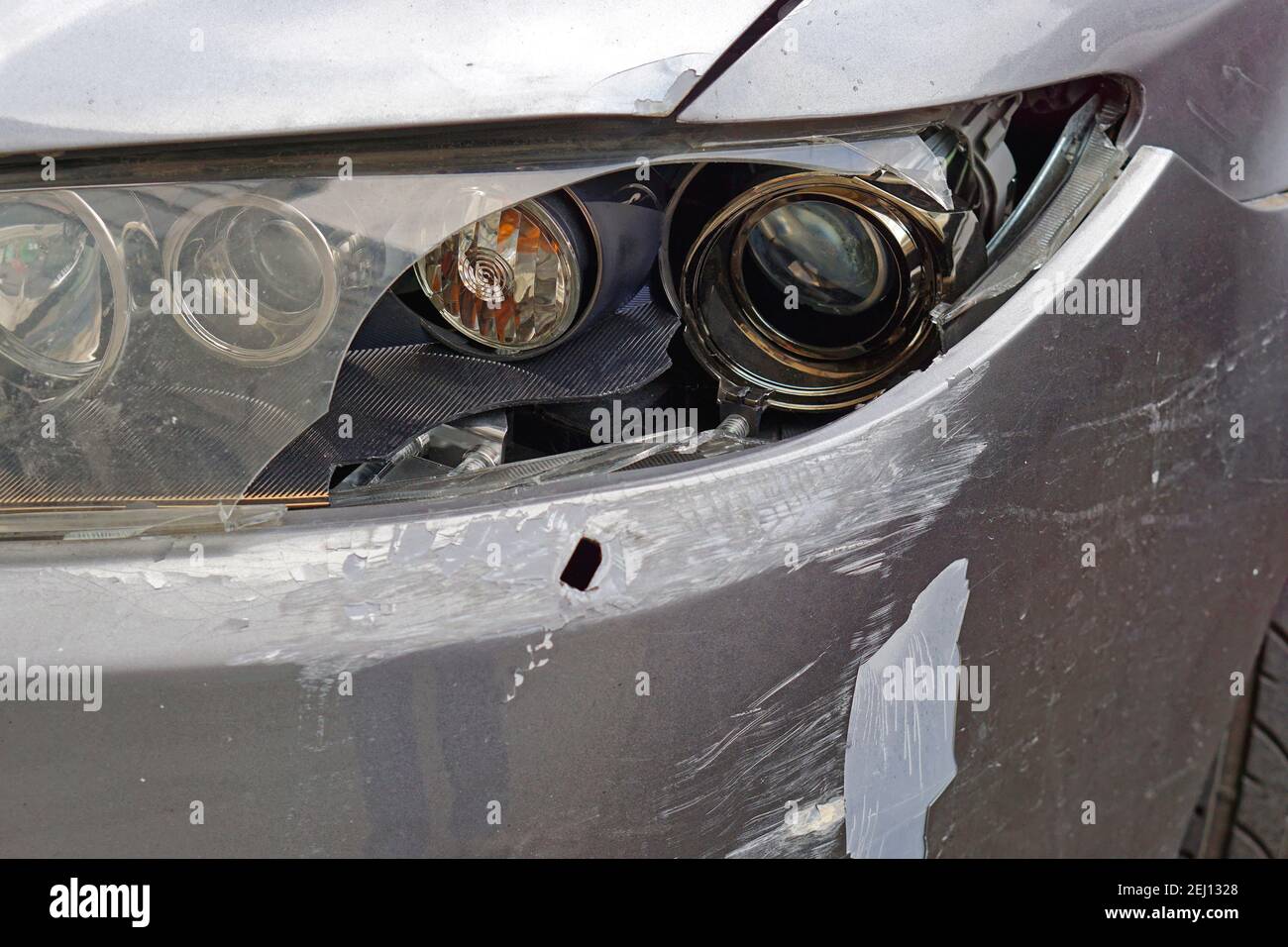 Damaged car broken headlights front bumper traffic accident Stock Photo