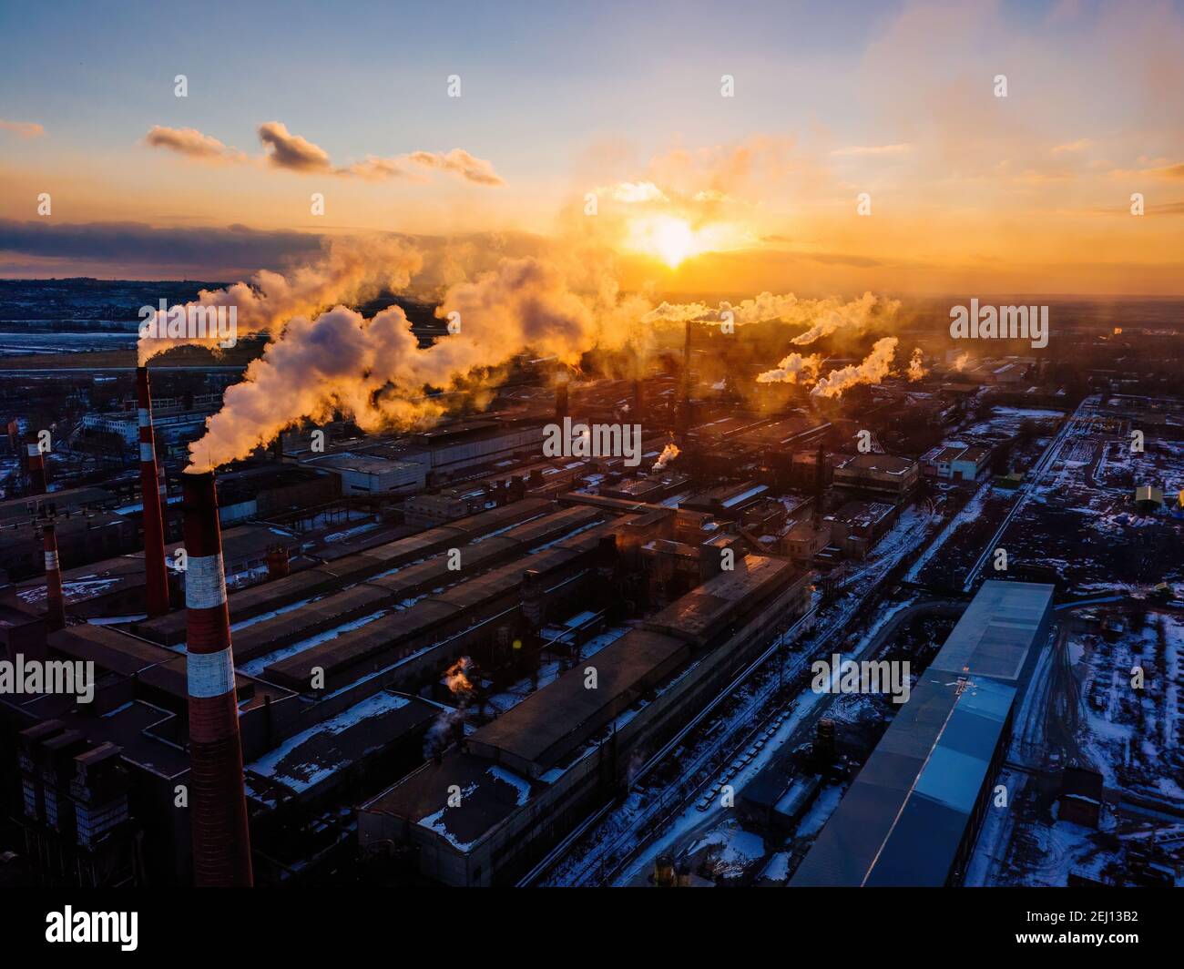 Factory Sunset Industrial landscape at the sunset, aerial view. Smoke coming out from ...