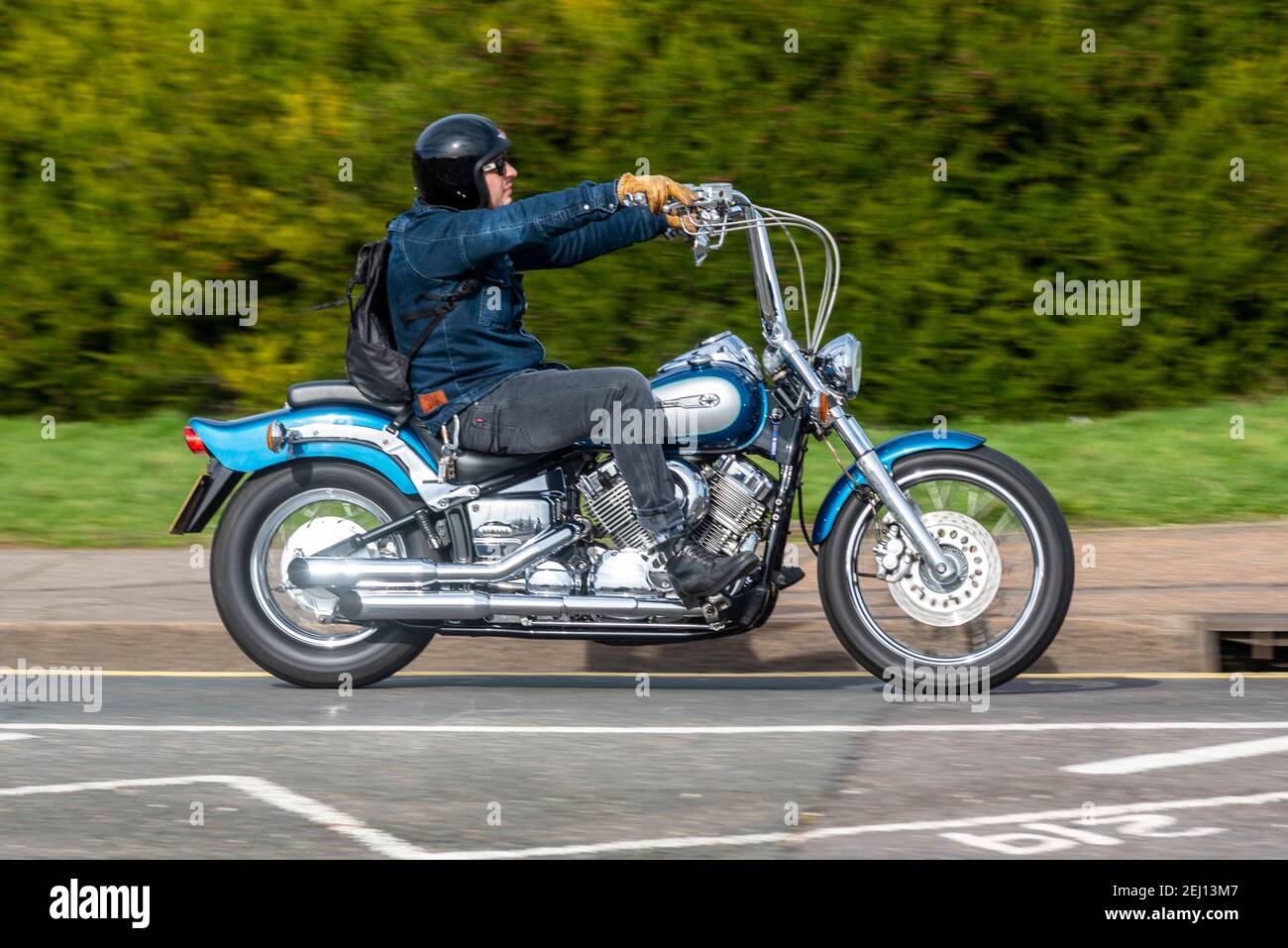Yamaha DragStar motorcycle on Western Esplanade in Southend on Sea, Essex, UK. Rider wearing denim jacket and jeans trousers on cruiser motorbike Stock Photo
