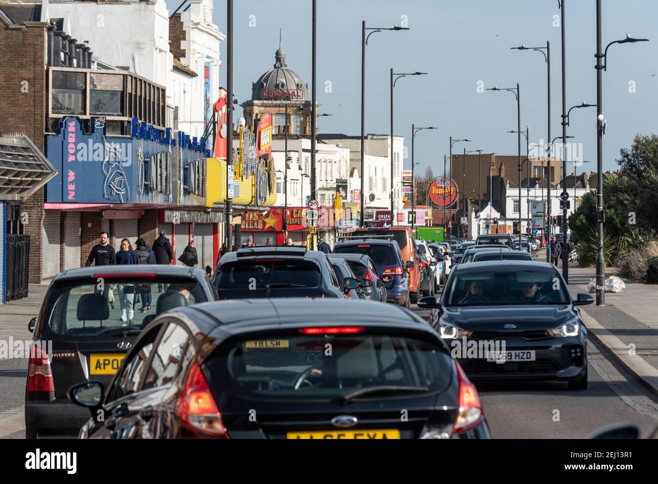 Queues of cars on Marine Parade on a sunny warm winter day in Southend on Sea, Essex, UK, during COVID 19 lockdown. Traffic queuing by closed business Stock Photo