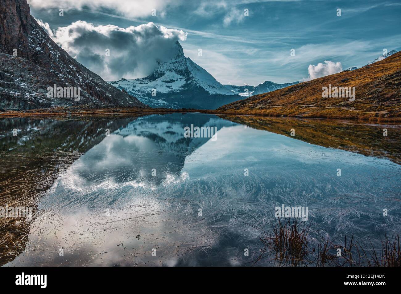 Panoramic view of Matterhorn peak, Switzerland. Matterhorn reflection in the Riffelsee. Stock Photo