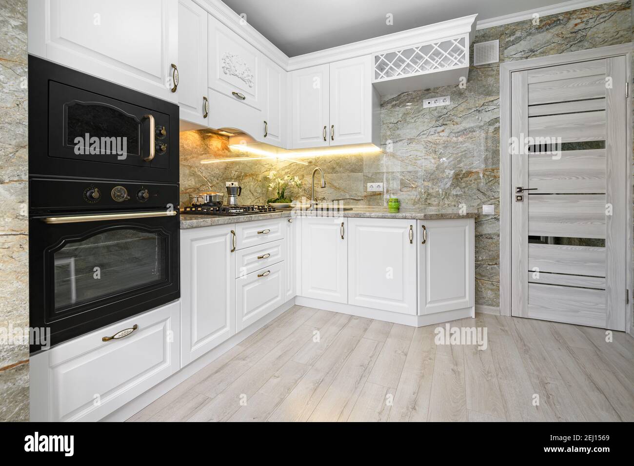 Modern classic white kitchen interior with wooden furniture Stock Photo