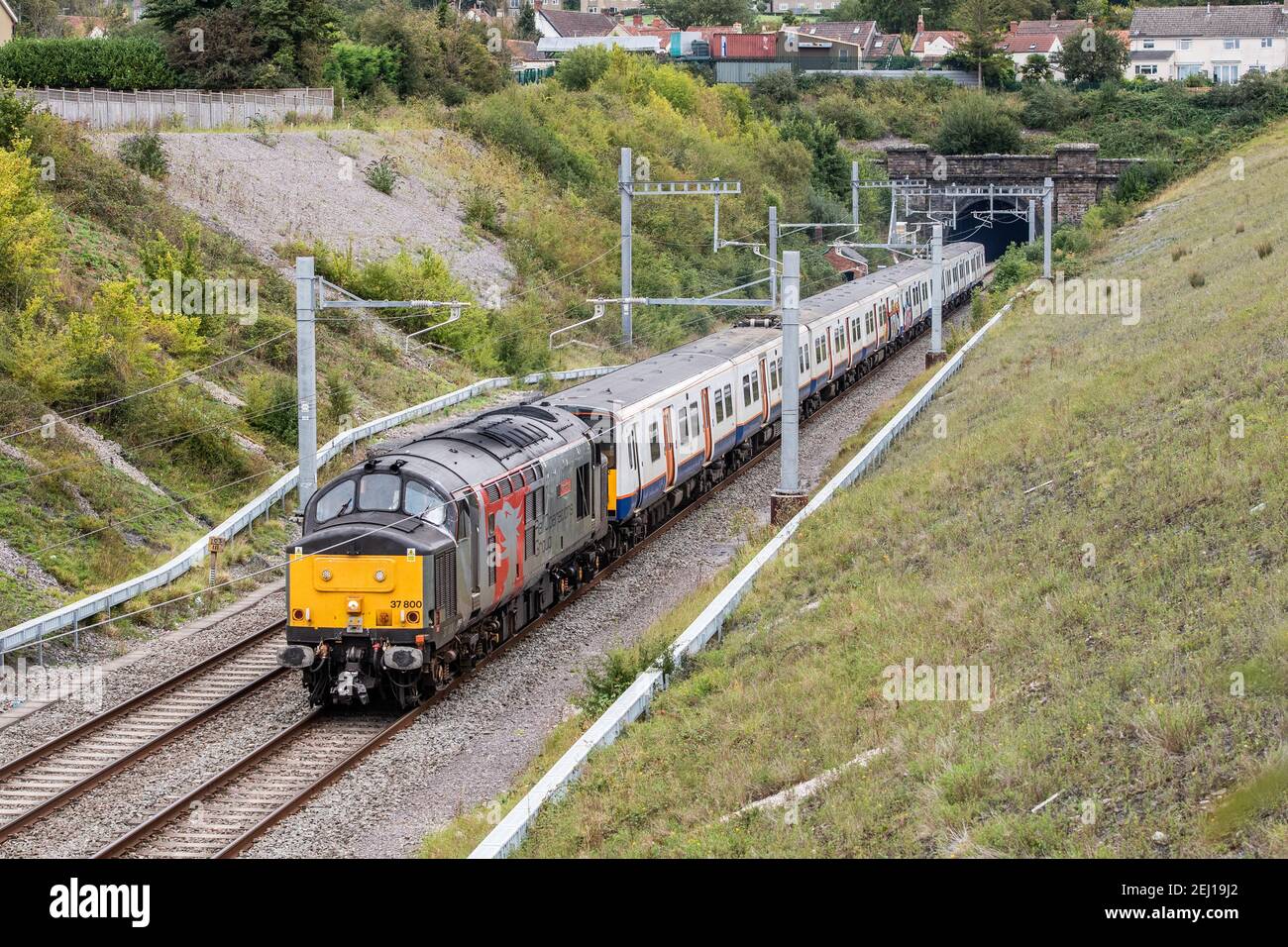 Rail Operations Group 37800 drags a pair of Ex London Overground 315 EMUs Nos. 315825 and 315812 through Chipping Sodbury en route to Newport Docks Stock Photo